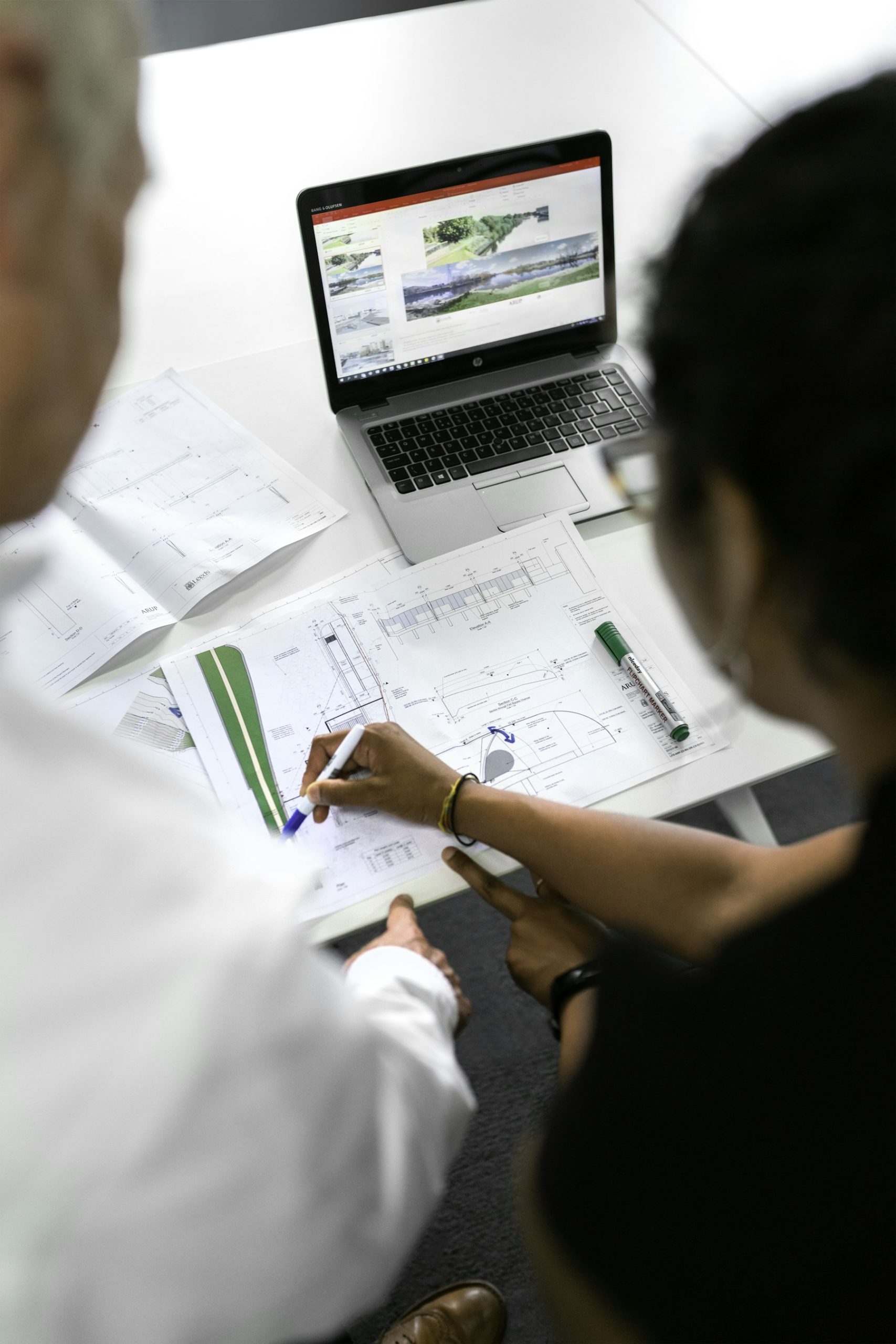 House plans spread across a desk with a pencil and ruler