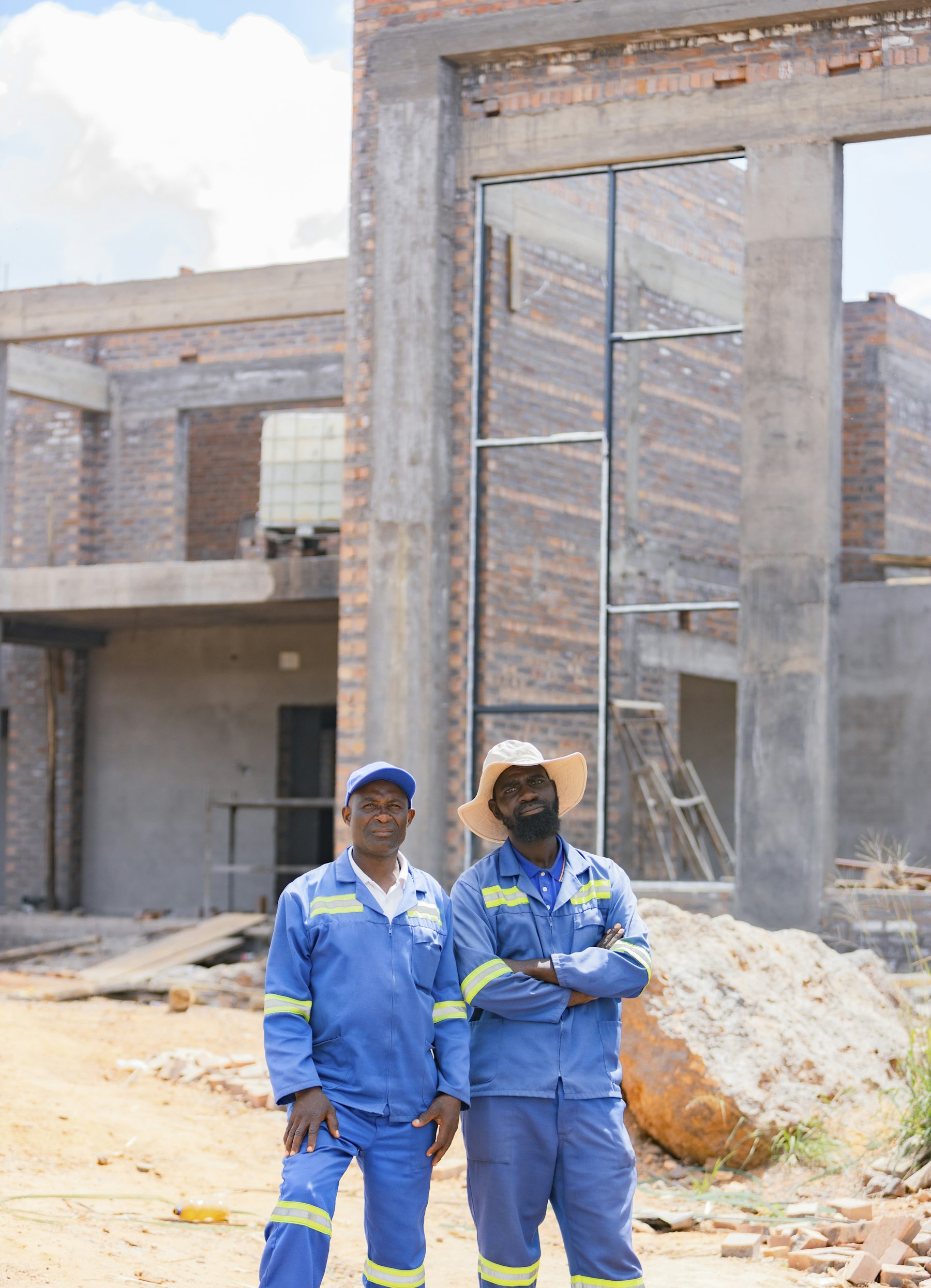 Bricklayer laying a course of bricks on a building site