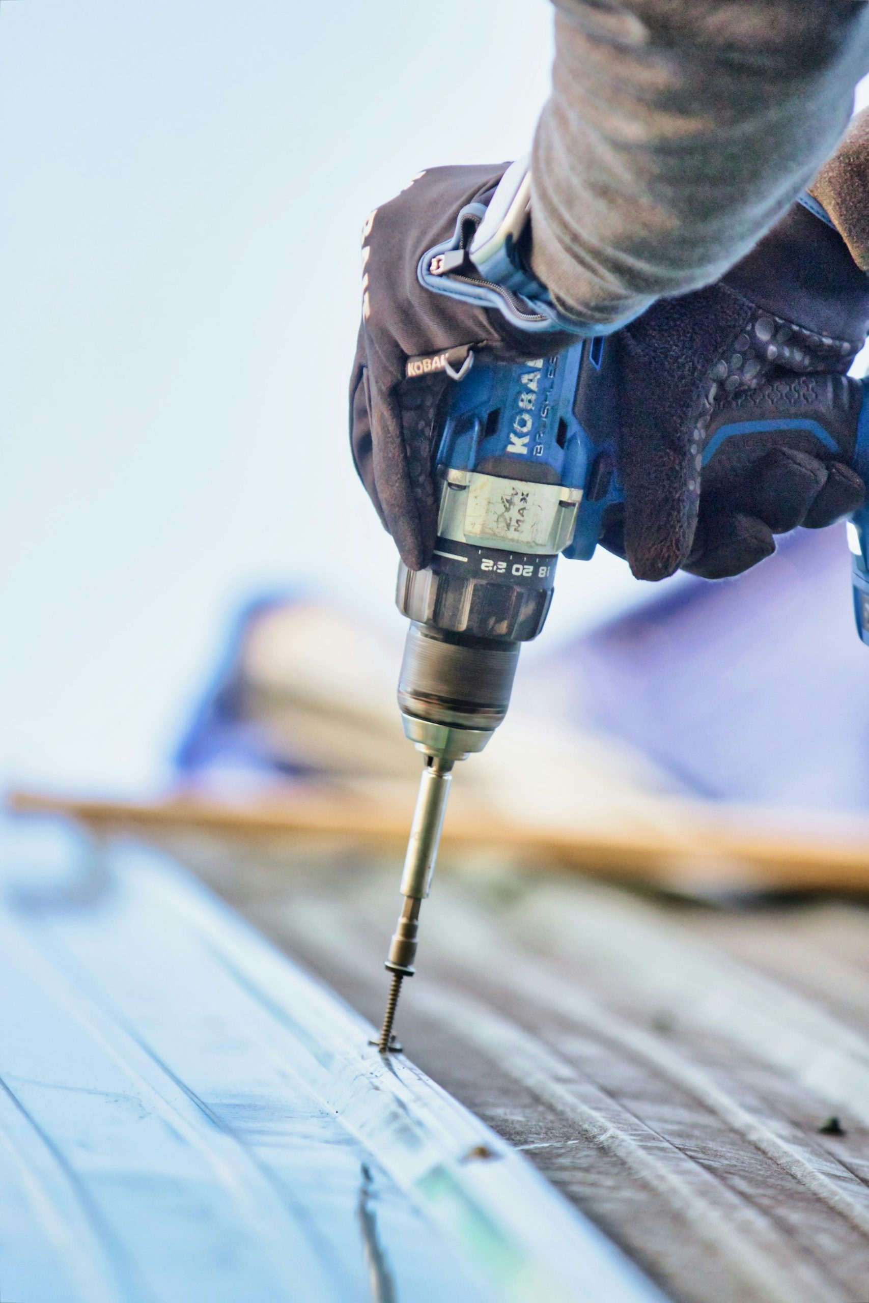 Cordless drill resting on a timber workbench