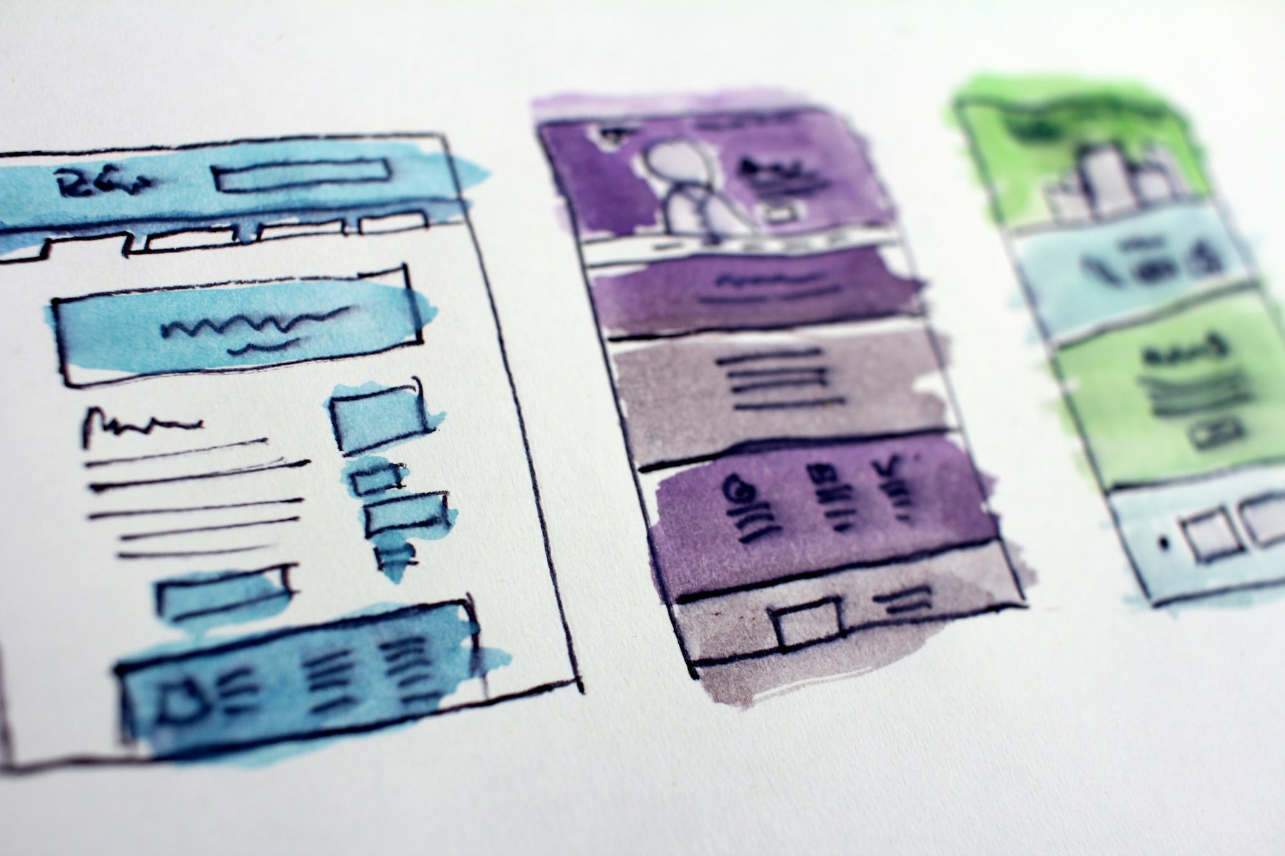 Website wireframes laid out on a desk